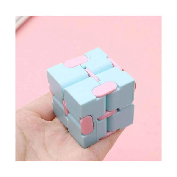 Cub Infinity Fidget, mână care ține un cub infinit albastru pastel cu elemente roz, pe fundal roz