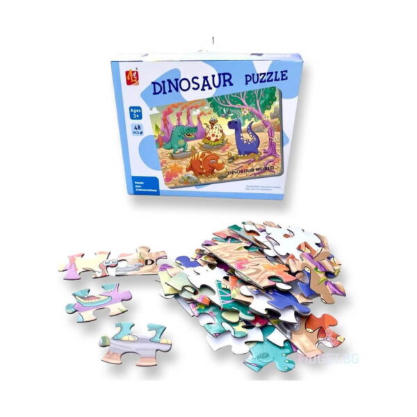 Puzzle distractiv dinozaur, cutia Dinosaur Puzzle deasupra unei grămezi de piese de puzzle colorate