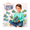 set-de-constructie-stem-tanar-inginer-10-in-1-utilizare Set de construcție STEM Tânăr inginer 10 în 1, băiat în bluză verde-mentă, așezat pe podea