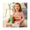 Set de jocuri educative, fetiță zâmbitoare care ține în brațe cutia Spoki deschisă