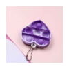 Set Pop It unicorn cu geantă și accesorii, breloc Pop It inimă mov cu alb, cu șase bule și lănțișor metalic, pe fundal roz.