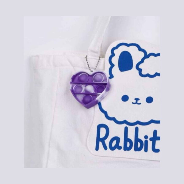 Set Pop It unicorn cu geantă și accesorii, breloc Pop It în formă de inimă, mov cu alb, cu șase bule și lănțișor cu bile